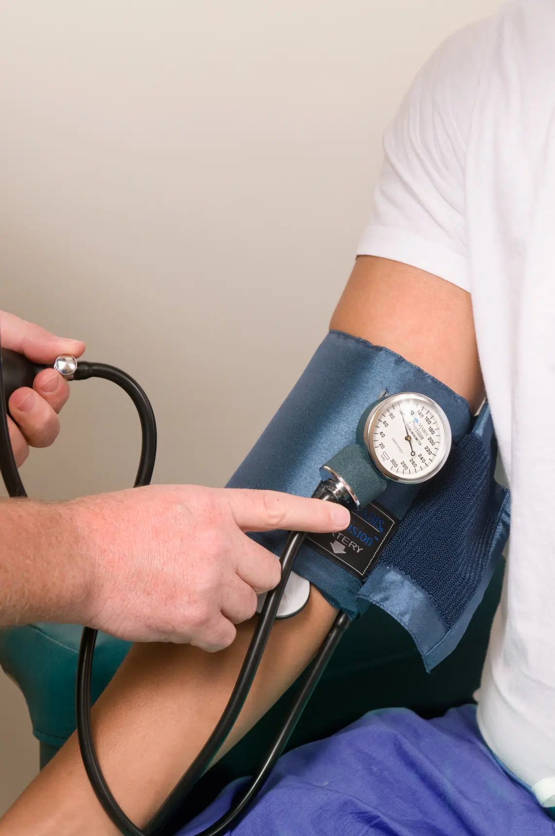 Person having their blood pressure checked with a cuff, representing medical evaluations and employee health considerations under CFRA.