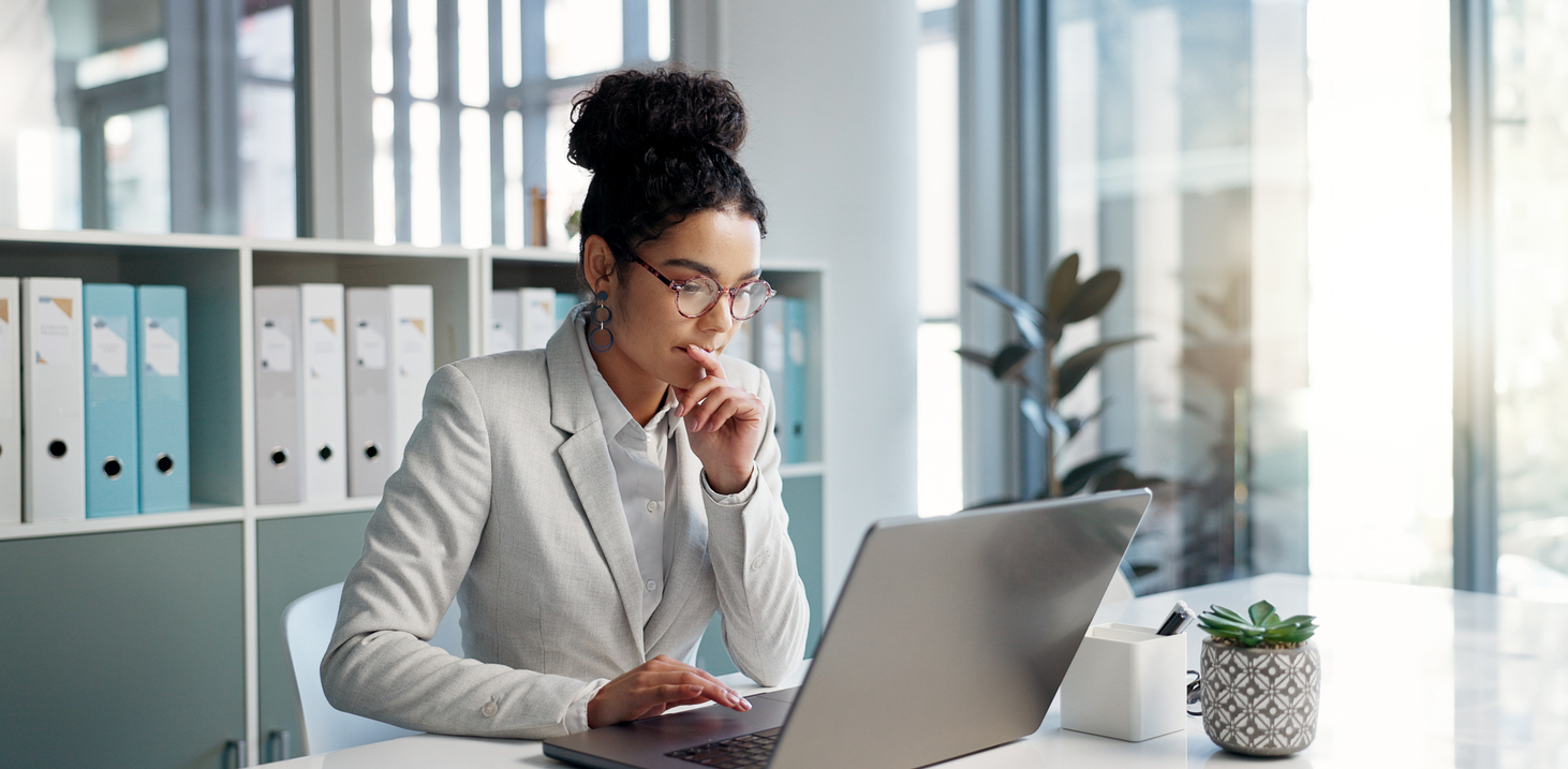 Thinking, laptop and typing business woman